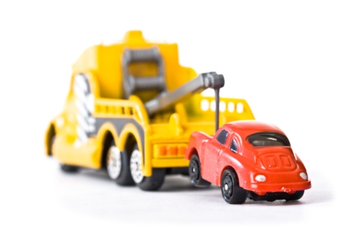 A toy car being towed